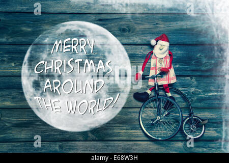 Frohe Weihnachten auf der ganzen Welt - mit Holz, Santa und eine alte Einrad dekoriert Grusskarte mit englischem Text.
