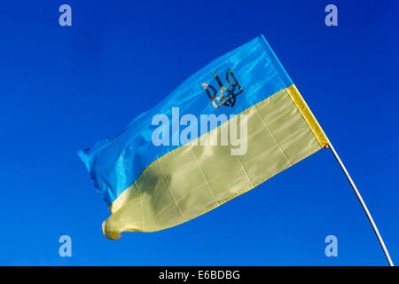 Ukrainische Flagge, die im Wind weht, mit einer dreizackig ukrainischen Flagge Stockfoto