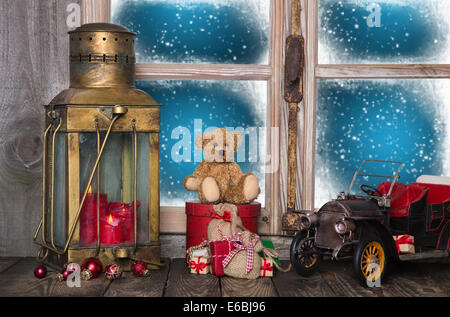 Alten Weihnachtsdekoration auf der hölzernen Fensterbank mit Vintage und nostalgischen Spielzeug. Stockfoto