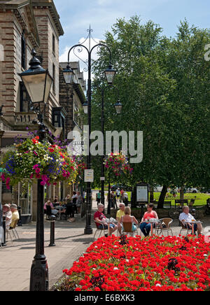 Menschen, die an Tischen vor Bars und Cafés entlang Montpellier sitzen Parade im Sommer Harrogate North Yorkshire England Vereinigtes Königreich Großbritannien Stockfoto