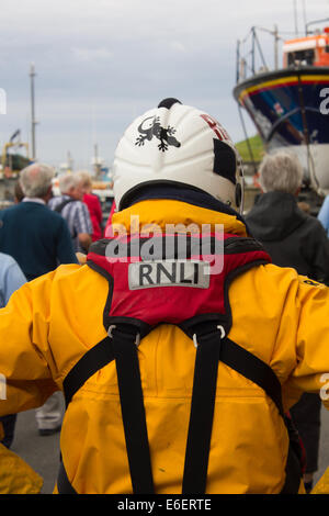 Crew-Mitglied geht hinter das Grace Darling Rettungsboot an eine RNLI-Übung, gemeinsame, Northumberland, Vereinigtes Königreich, Großbritannien Stockfoto