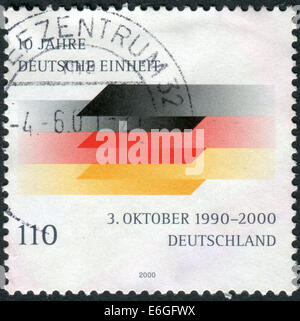 Briefmarke gedruckt in Deutschland, widmet sich den 10. Jahrestag der deutschen Wiedervereinigung Stockfoto