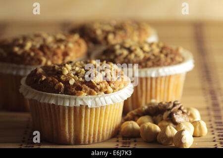 Muffins mit Boden Haselnüssen garniert mit Tee serviert. Stockfoto