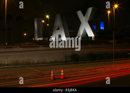 Das LAX unterzeichnen am Eingang zum Los Angeles International Airport mit Auto Lichter im Vordergrund Stockfoto