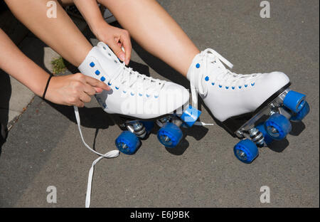 Von ein paar Quad Skates schnürt Befestigung Rollschuhen die weißen binden Stockfoto