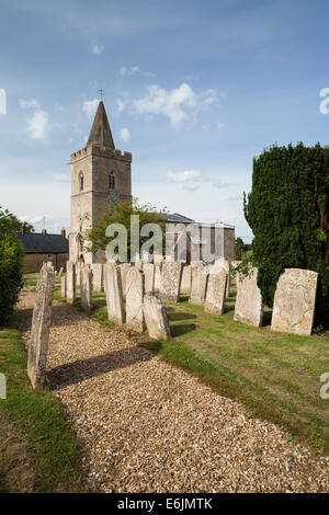 Das Dorf Kirche St. Mary die Jungfrau an einem Sommerabend mit Grabsteinen Futter einen Kiesweg, Morcott in Rutland, England. Stockfoto