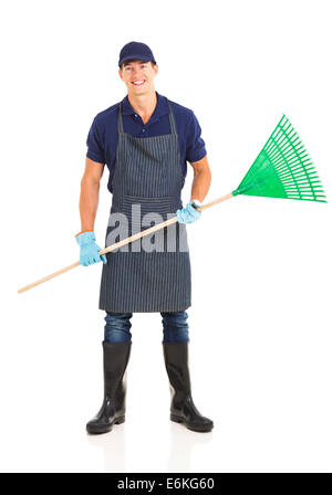 hübscher junger Bauer hält einen Garten Rechen Stockfoto