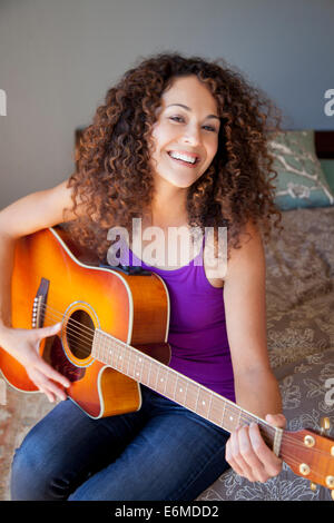 Porträt der Frau spielt Gitarre Stockfoto