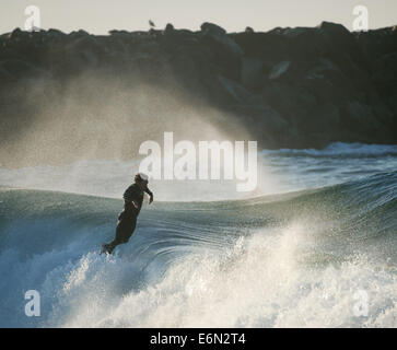 Newport Beach, Kalifornien, USA. 25. August 2014. Eine Surfer öffnet sich über eine Welle nach der Fahrt des Satzes fast zur Küste auf den Keil am Dienstag Morgen.---Hurricane Marie brachte größer als übliche Surf, der Keil in Newport Beach am Dienstag, woraufhin Surfer für den Strand auf der Suche nach die perfekte Fahrt. © David Bro/ZUMA Draht/Alamy Live-Nachrichten Stockfoto