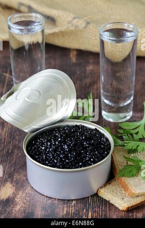 Kaviar mit Roggenbrot und zwei Schüsse Wodka auf einem Holztisch Stockfoto