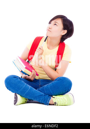 junge Studentin am Boden mit Buch und denken Stockfoto