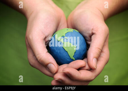 Frauenhand mit Plastilin Planet (Child's Play Ton). Closeup. Planeten, die von mir gemacht. Stockfoto