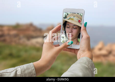 Junges Mädchen unterwegs und fotografiert ihr selbst Selfie Stockfoto