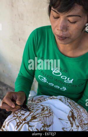 Yogyakarta, Java, Indonesien.  Batik-Produktion.  Frau mit heißem Wachs, eine Design auf eine Batik Tuch zu skizzieren. Stockfoto