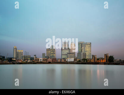 Die Türme des Finanzviertels Canary Wharf spiegeln sich bei Sonnenaufgang der Golden Hour in der Themse, London, England, Großbritannien. Stockfoto