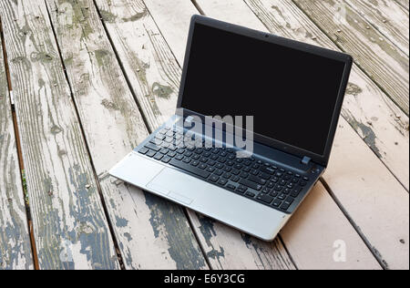 Laptop mit schwarzer Bildschirm auf dem Holztisch Stockfoto