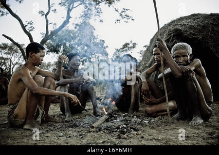 Eine Frau und vier Männer aus dem San-Stamm sitzen um ein Lagerfeuer, Otjozondjupa Region, Namibia, Afrika Stockfoto