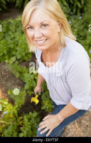 Ältere Frau im Garten Stockfoto