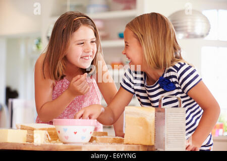 Mädchen, die Zutaten zu essen, während die Käse auf Toast Stockfoto