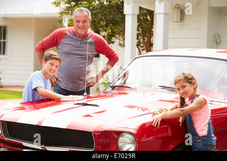 Großvater mit Enkel Reinigung restaurierte Oldtimer Stockfoto