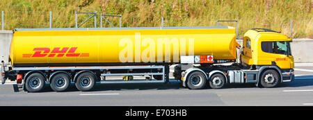 Seitenansicht DHL Logo auf Logistikbereich Supply Chain Tankwagen Anhänger und LKW auf Autobahn Geschäft von Deutsche Post DHL England UK Stockfoto