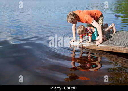 Vater und Sohn blickte in See von Pier, Somerniemi, Finnland Stockfoto