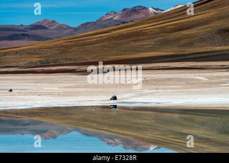 Reflexion der Berge und Auto im Wasser am Laguna Verde (grüne Lagune) Bolivien Südamerika Stockfoto