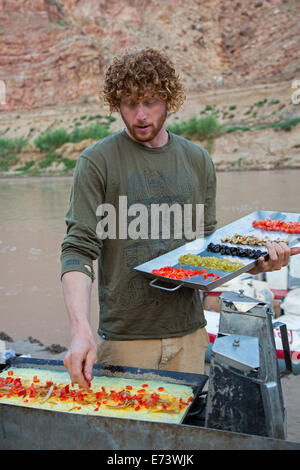 Canyonlands National Park, Utah - Flussführer Julian Springer macht Omelettes zum Frühstück während einer Floßfahrt Stockfoto