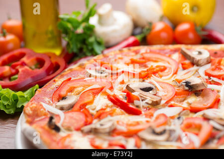 Italienische Pizza mit Pilzen und Zwiebeln auf Holztisch Stockfoto