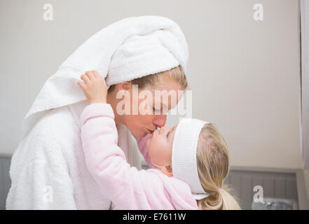 Niedliche kleine Mädchen mit Mutter im Bademantel Stockfoto