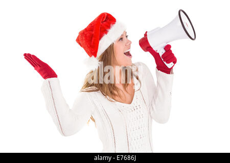 Festliche Blondine durch Megaphon schreien Stockfoto