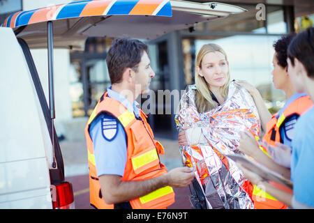 Sanitäter im Gespräch mit Patienten im Krankenhaus-Parkplatz Stockfoto