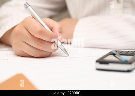 Geschäftsfrau anzeigen den Vertrag vor der Unterzeichnung. Close-up. Pen im Mittelpunkt. Geringe Schärfentiefe. Stockfoto
