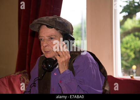 Frau mit alten altmodischen Telefonhörer und Zigarette, London, UK Stockfoto