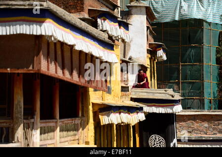 (140912)--XIAHE, 12. September 2014 (Xinhua)--A tibetisch-buddhistischen Mönch sitzt in der Nähe ein Sanierungsprogramm in der Residenz des ersten Jamyang Shepa, Gründer des Klosters Labrang in Xiahe County der Gannan tibetischen autonomen Präfektur im Nordwesten Chinas Provinz Gansu, 2. September 2014. Labrang Kloster, einem großen tibetischen Buddhismus-Kloster in China, erlebt die größte Renovierung Programm seit seiner Gründung im Jahre 1709. Die Renovierung, die im April 2013 gestartet, soll ersetzen Stein- und hölzernen Strukturen innerhalb des Klosters, die von der ye abgenutzt Stockfoto