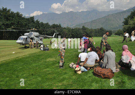 Flut betroffenen Kaschmir Bürger und Touristen warten, um einen indischen Luftwaffe Mi-17 Hubschrauber während der Rettungs- und Hilfskräfte Vorgänge nach Überschwemmungen in Srinagar am 11. September 2014 an Bord. Überschwemmungen und Erdrutsche von Tagen von heftigen Monsunregen haben jetzt mehr als 450 lebt in Pakistan und Indien, mit Krankenhäusern, die kämpfen, um mit der Katastrophe fertig zu werden behauptet © Stringer/Pacific Press/Alamy Live News Stockfoto