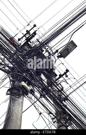 Viele Kabel Kreuzung an zwei Strommasten auf 9 de Octubre Street in Quito, Ecuador Stockfoto