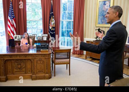 US-Präsident Barack Obama Witze mit Mattina Falco, 19-Year-Old Make-A-Wish Empfänger als sie sitzt auf der Resolute Desk im Oval Office des weißen Hauses 17. Juli 2014 in Washington, DC. Stockfoto