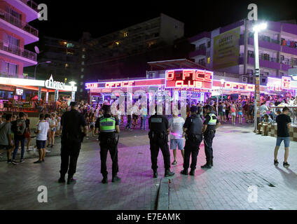 Polizisten sehen junge britische Touristen in Punta Ballena in Magaluf auf der spanischen Insel Mallorca genießen Stockfoto