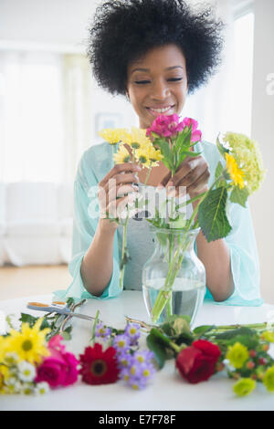 Afrikanische amerikanische Frau, die Vermittlung von Blumen Stockfoto