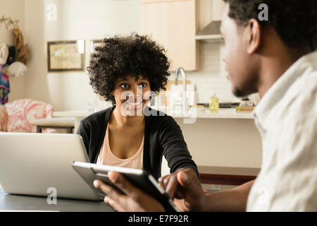 Paar mit Technik am Frühstückstisch Stockfoto