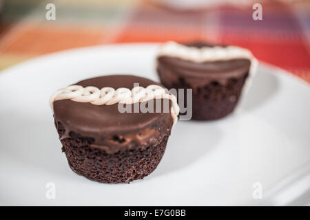 Hostess Cupcakes. Hostess Cupcakes bestehen Schokoladenkuchen mit cremigen Füllung im Inneren und einer Wellenlinie Sahnehäubchen-Linie durch die Stockfoto