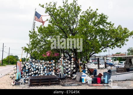 Zerfetzt und zerrissen US amerikanische Flagge snagged auf einem Ast an einem Straßenrand stehen Verkauf Styropor Schwimmer in den Florida Keys, USA. Stockfoto