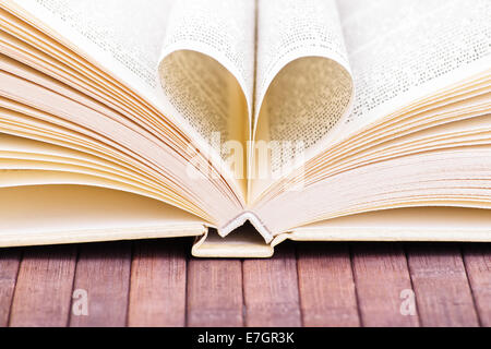 Nahaufnahme der Ein offenes Buch mit zwei Seiten bilden ein Herz. Stockfoto