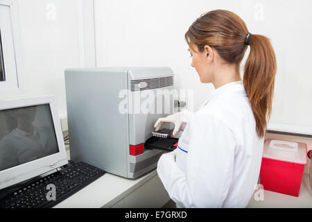 Techniker-laden-Analyzer mit Proben Stockfoto