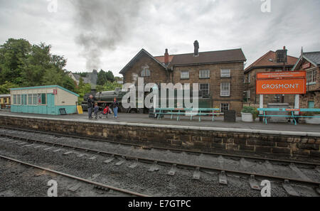 Dampfzug und historische Lokomotive am Bahnhof Grosmont auf Linienverkehr von Pickering nach Whitby, England Stockfoto