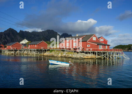 Rorbuer Fischerhütten mit einem kleinen Motorboot, Henningsvær, Lofoten, Nordland, Norwegen Stockfoto