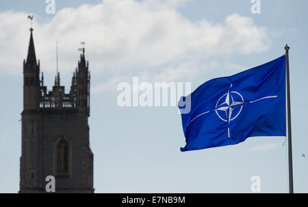 Ein NATO-Flagge weht in Cardiff Castle mit St.-Johannes Kirche in folgendem Hintergrund des NATO-Gipfels in Newport statt. Stockfoto