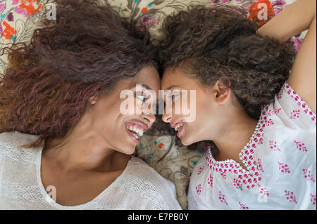 Mutter und Tochter (8-9) auf Bett liegend Stockfoto