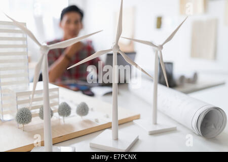 Architekt im Hintergrund, Wind-Turbine-Modelle auf Schreibtisch Stockfoto